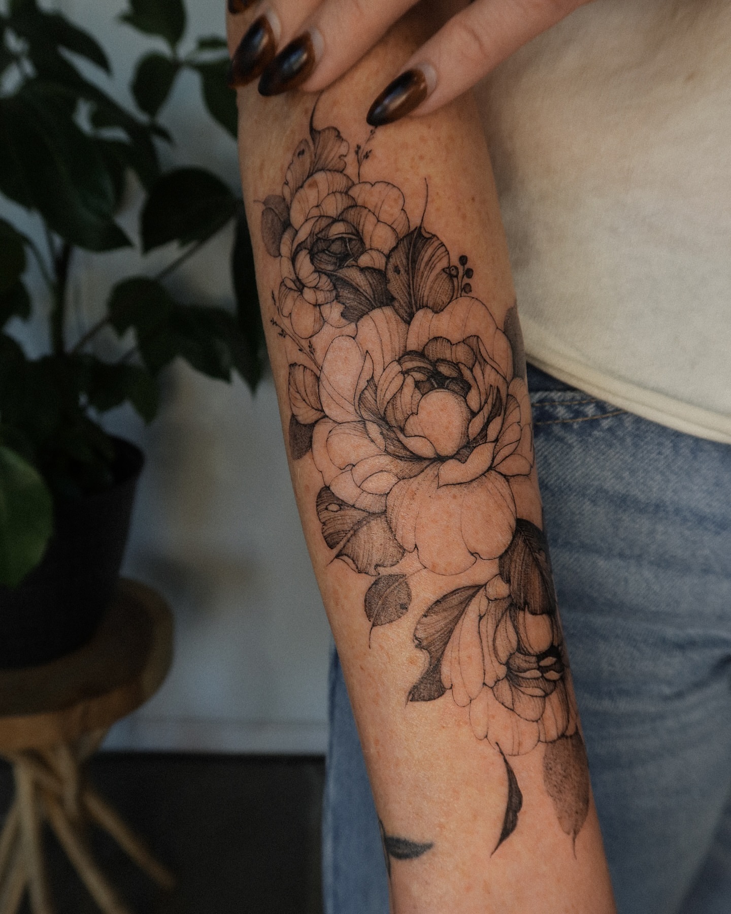 Floral bouquet black and grey tattoo on the forearm by Maria