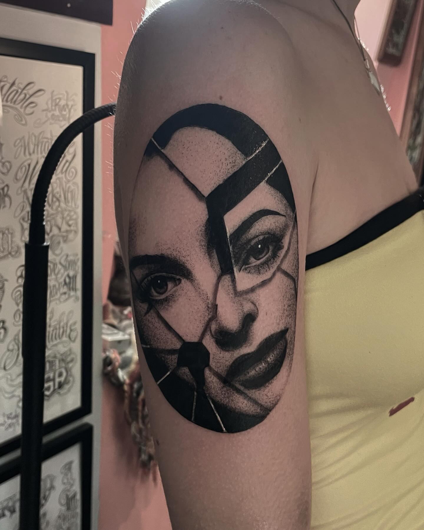 Woman's face dotwork tattoo on the shoulder by Ian Spong