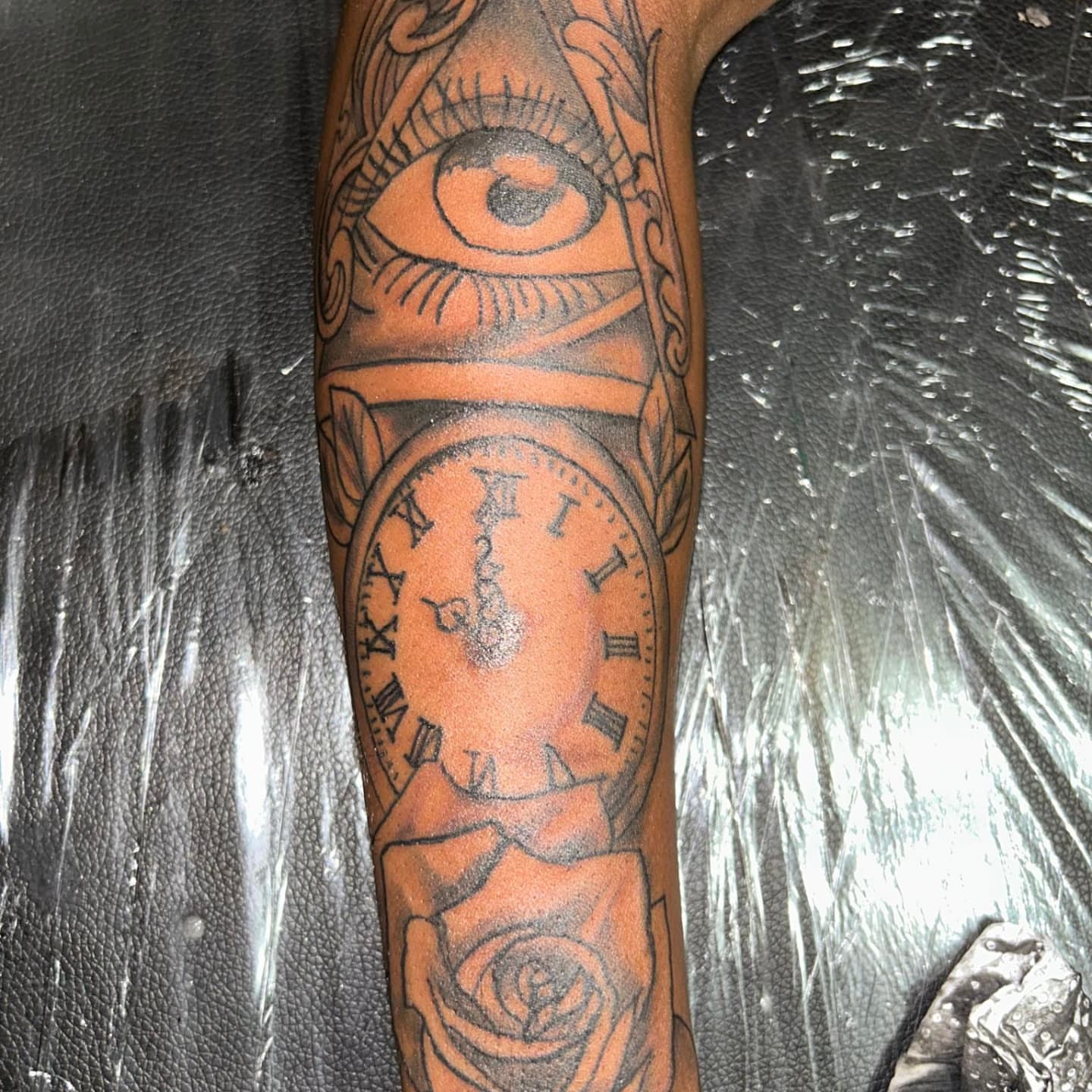 Eye and clock American traditional tattoo on the forearm by Trent Johnson