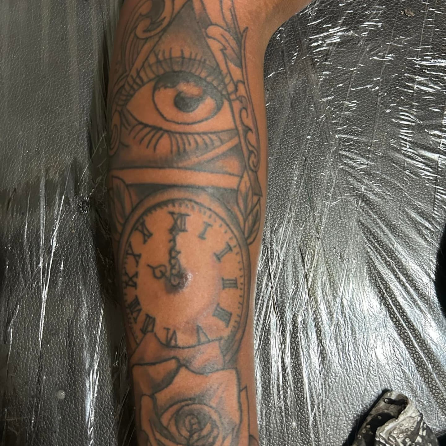 Eye and clock American traditional tattoo on the forearm by Trent Johnson
