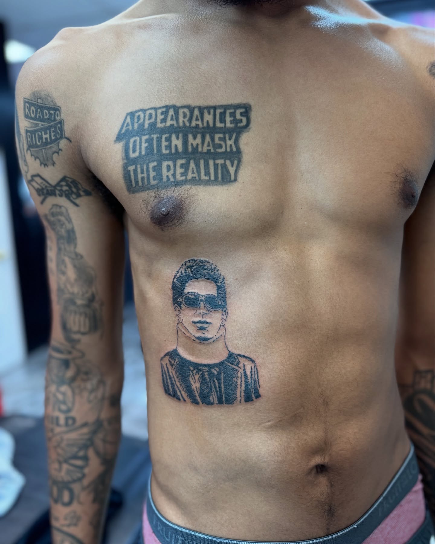 Portrait of a man black and grey tattoo on the chest by Honey