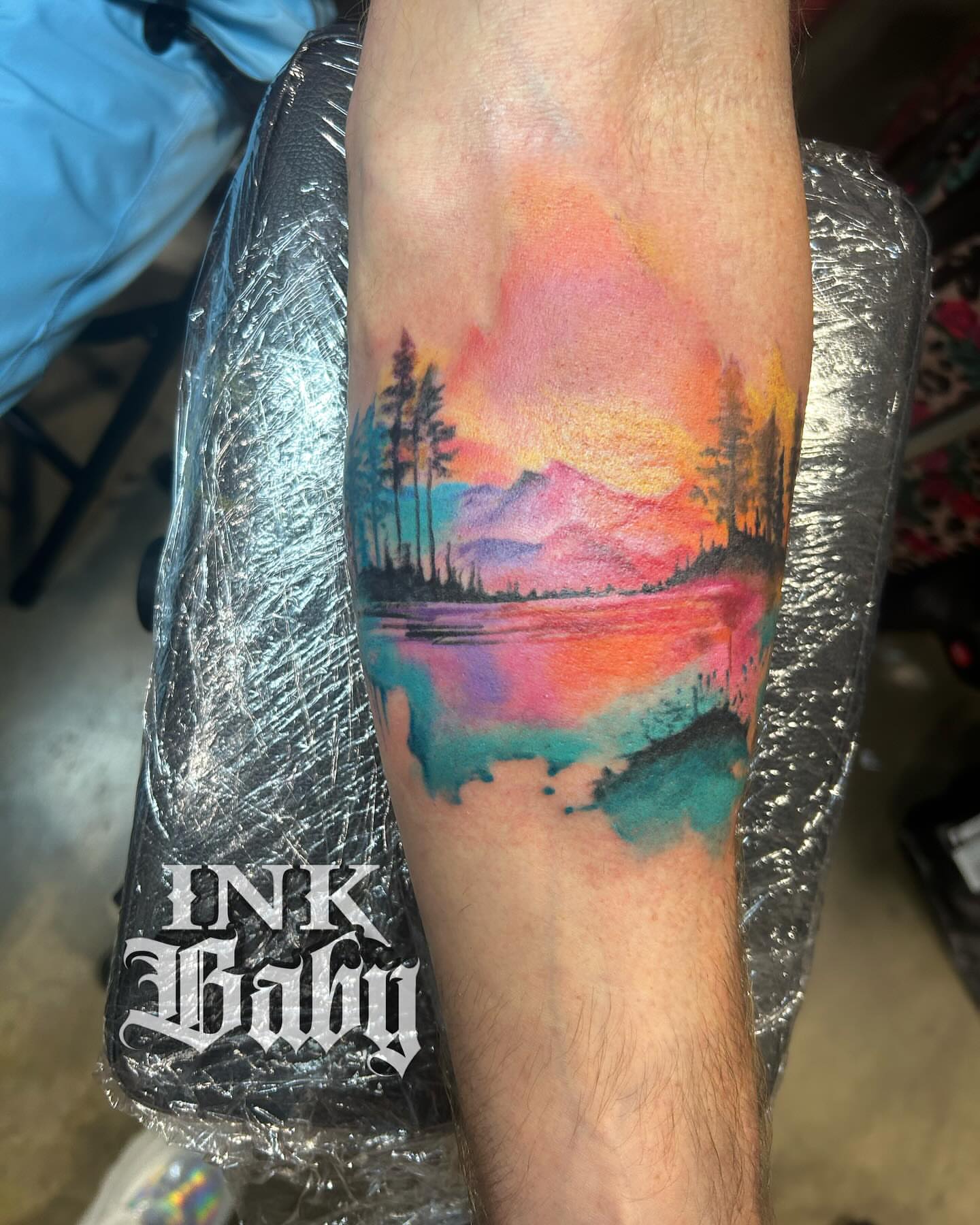 Watercolor landscape watercolor tattoo on the forearm by Ayanna Luna