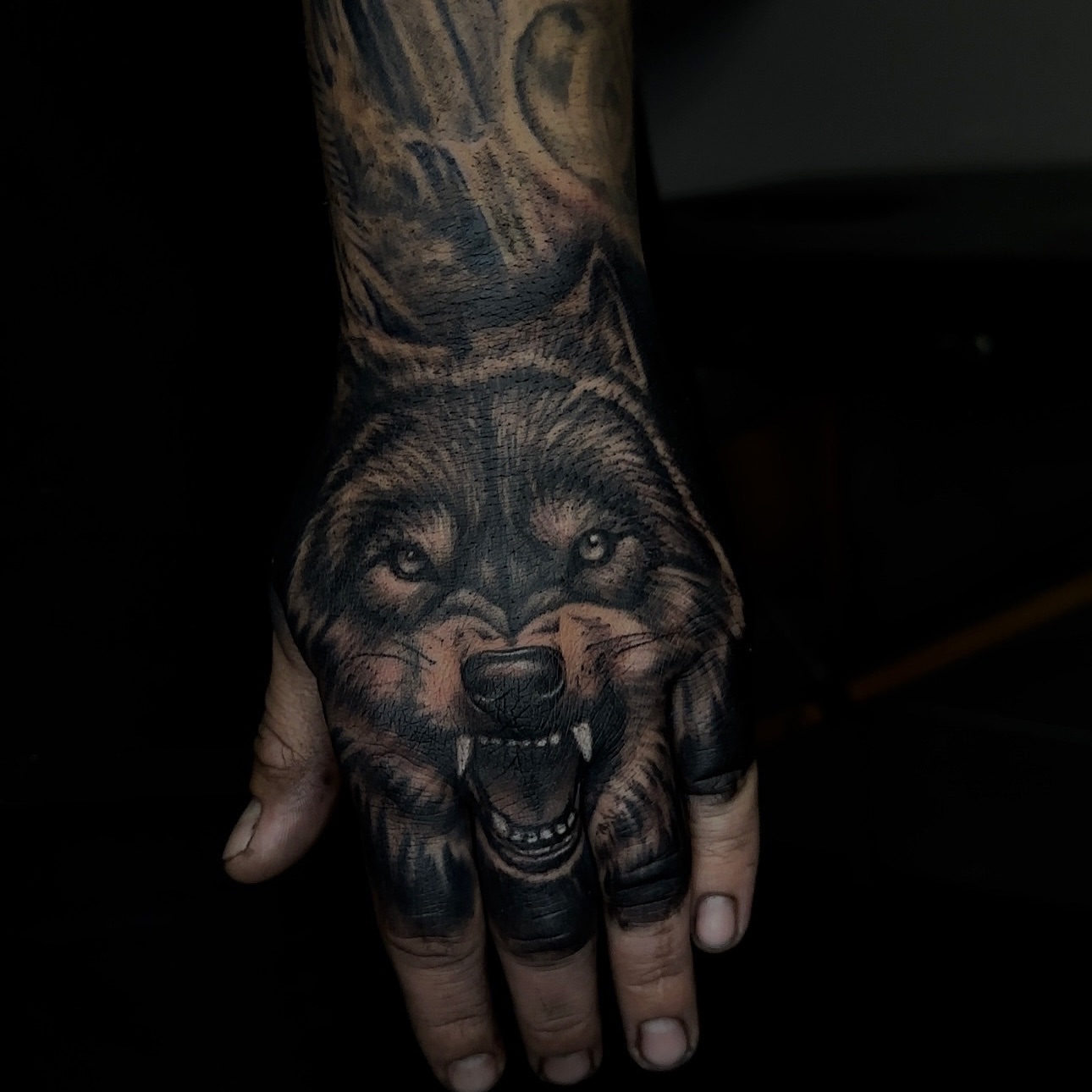Wolf realism tattoo on the hand by Ray Ochoa