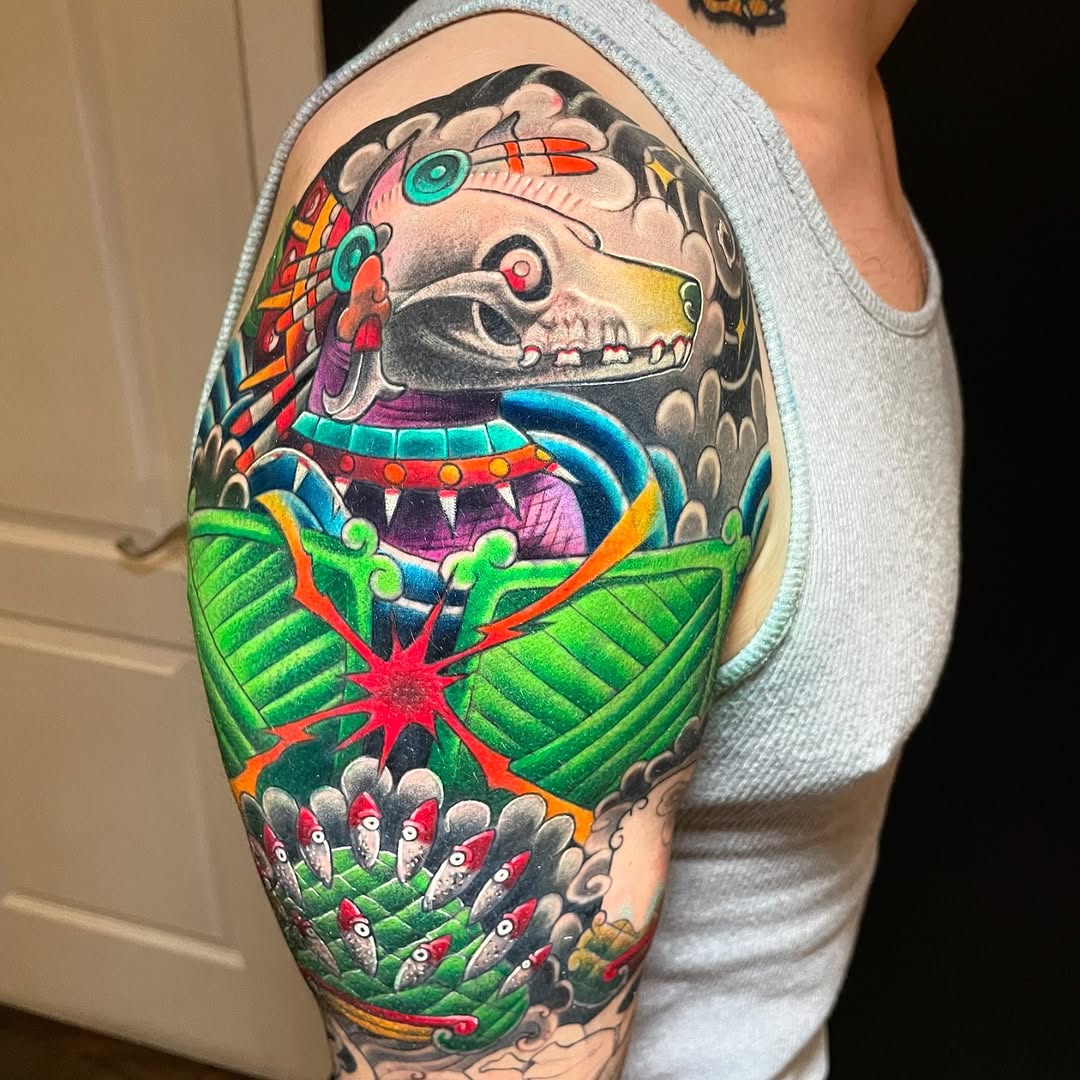 Mythological dog skull headdress Japanese tattoo on the upper arm by Meza Cruz