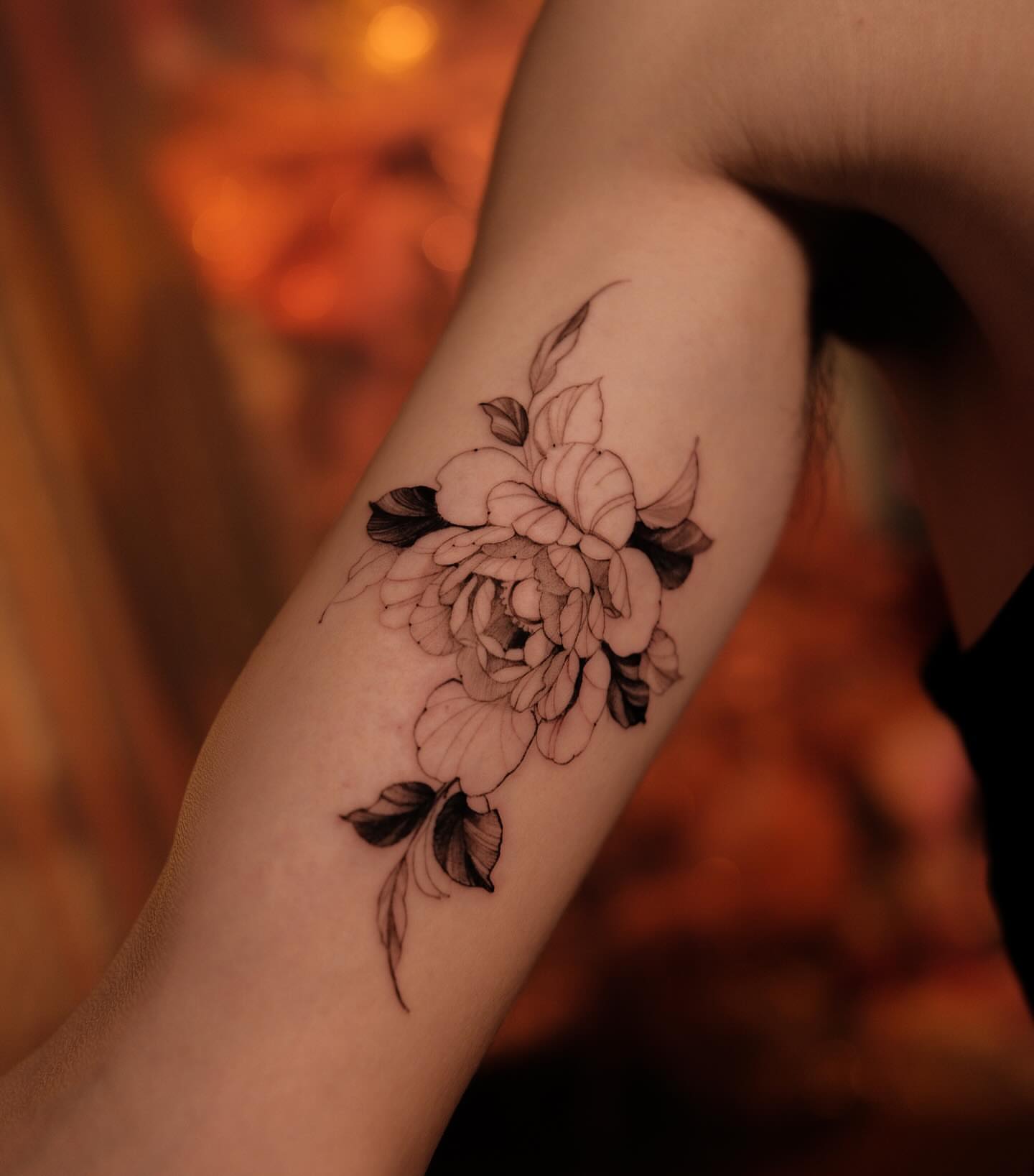 Floral bouquet black and grey tattoo on the forearm by Navei