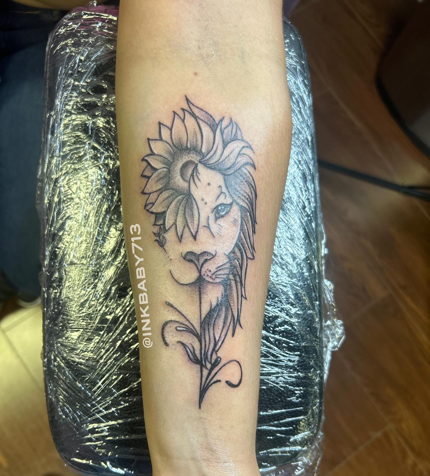 Lion and sunflower realism tattoo on the forearm by Ayanna Luna