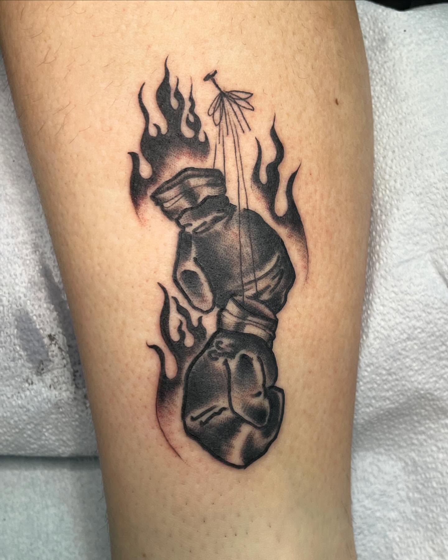 Firefighter helmet and hose realism tattoo on the forearm by G. Clover ⚧︎, Chicago, Illinois