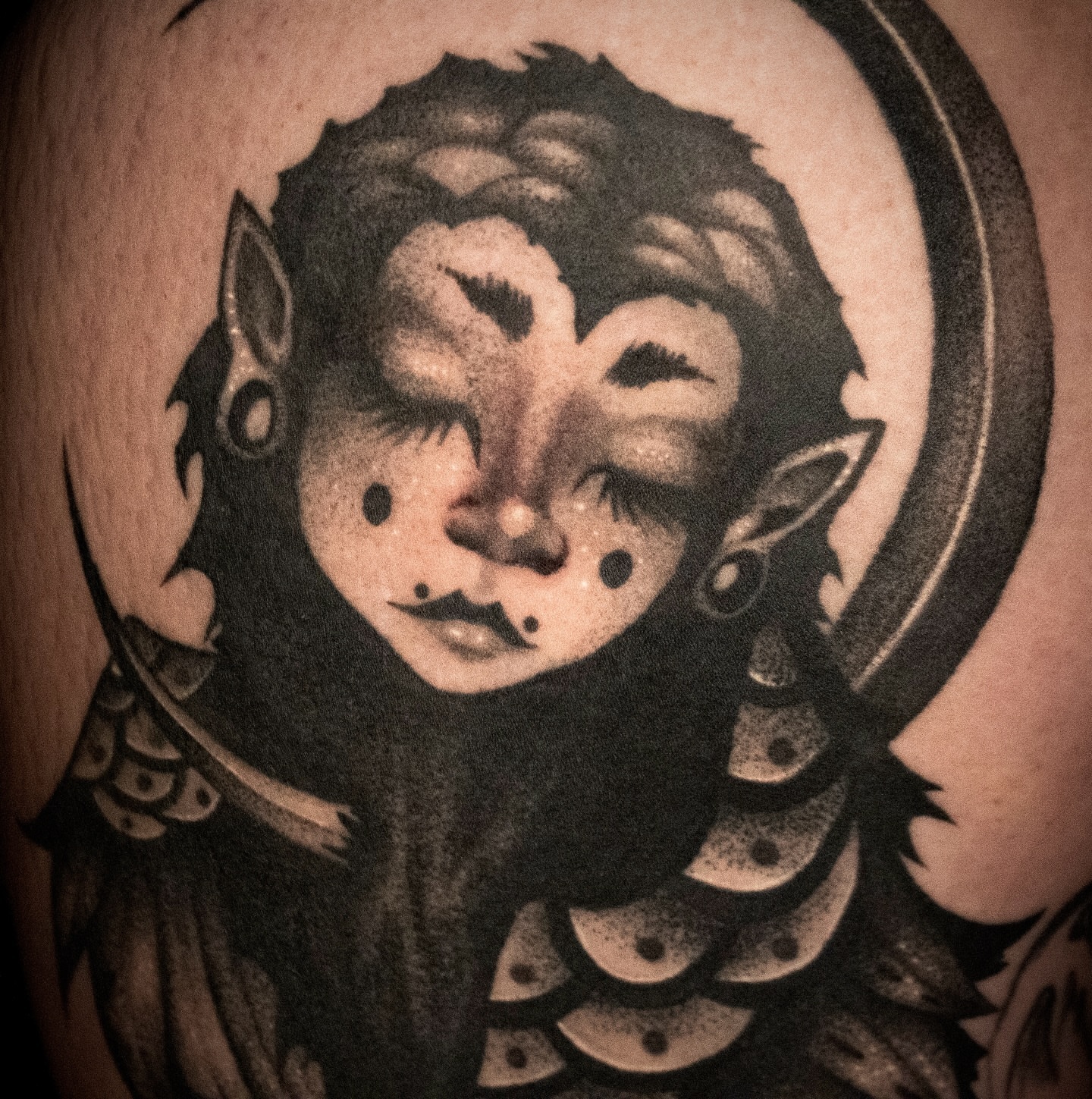 Elf-like creature black and grey tattoo on the shoulder by Galen
