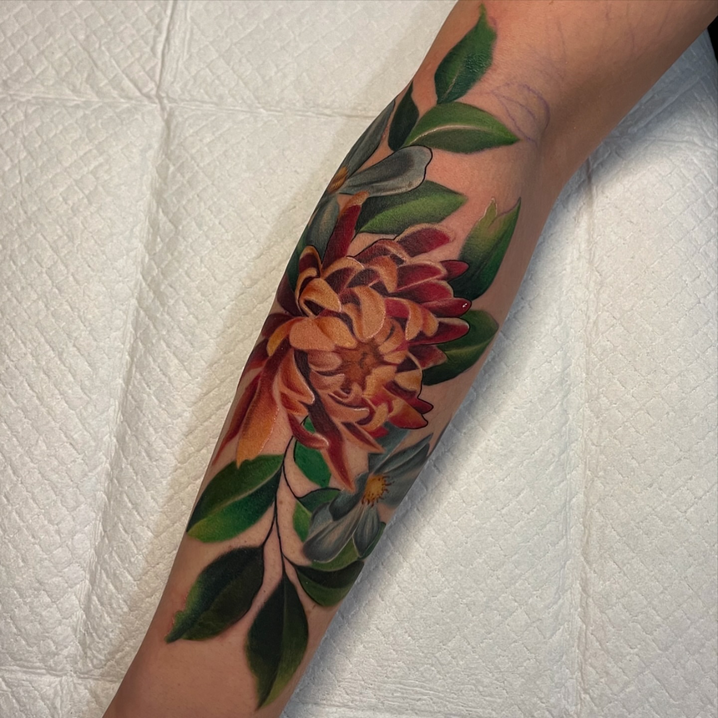 Floral arrangement realism tattoo on the forearm by Brittany Welsh, Marlton, New Jersey