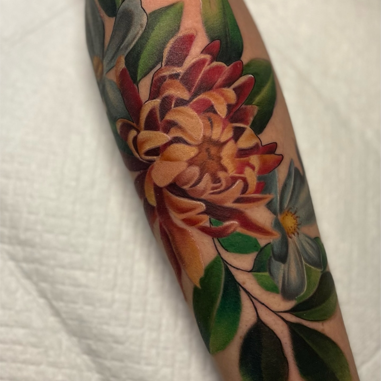 Floral arrangement realism tattoo on the forearm by Brittany Welsh, Marlton, New Jersey