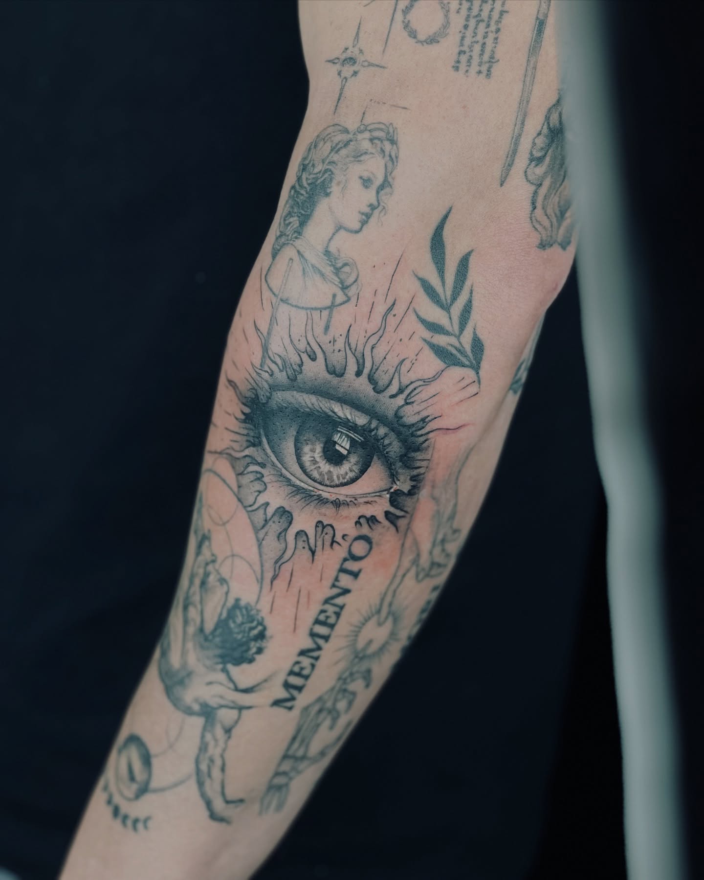 Eye and woman realism tattoo on the forearm by Apologies tattoo studios.