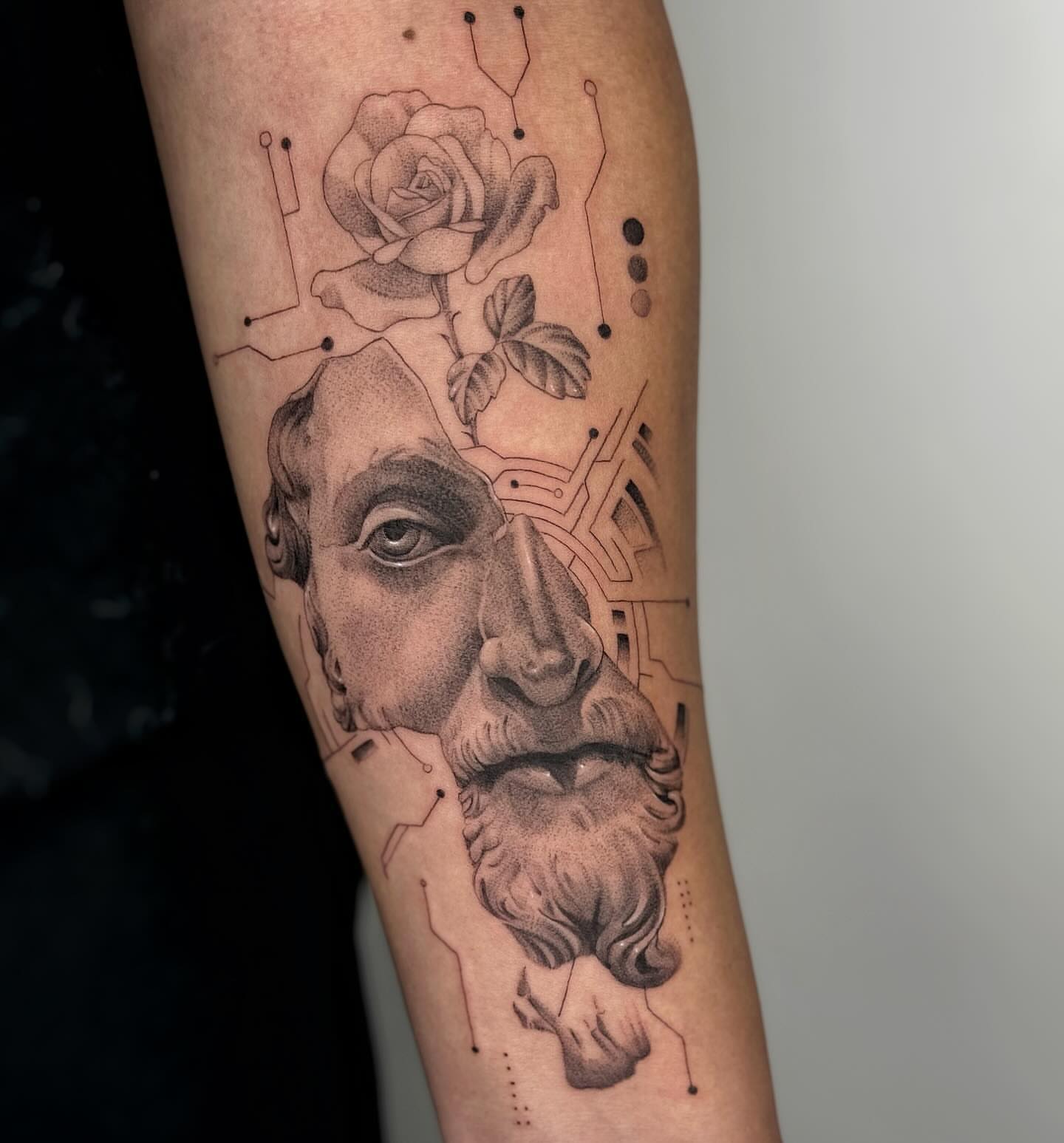 Ancient man with rose realism tattoo on the forearm by Alyssa . Villela