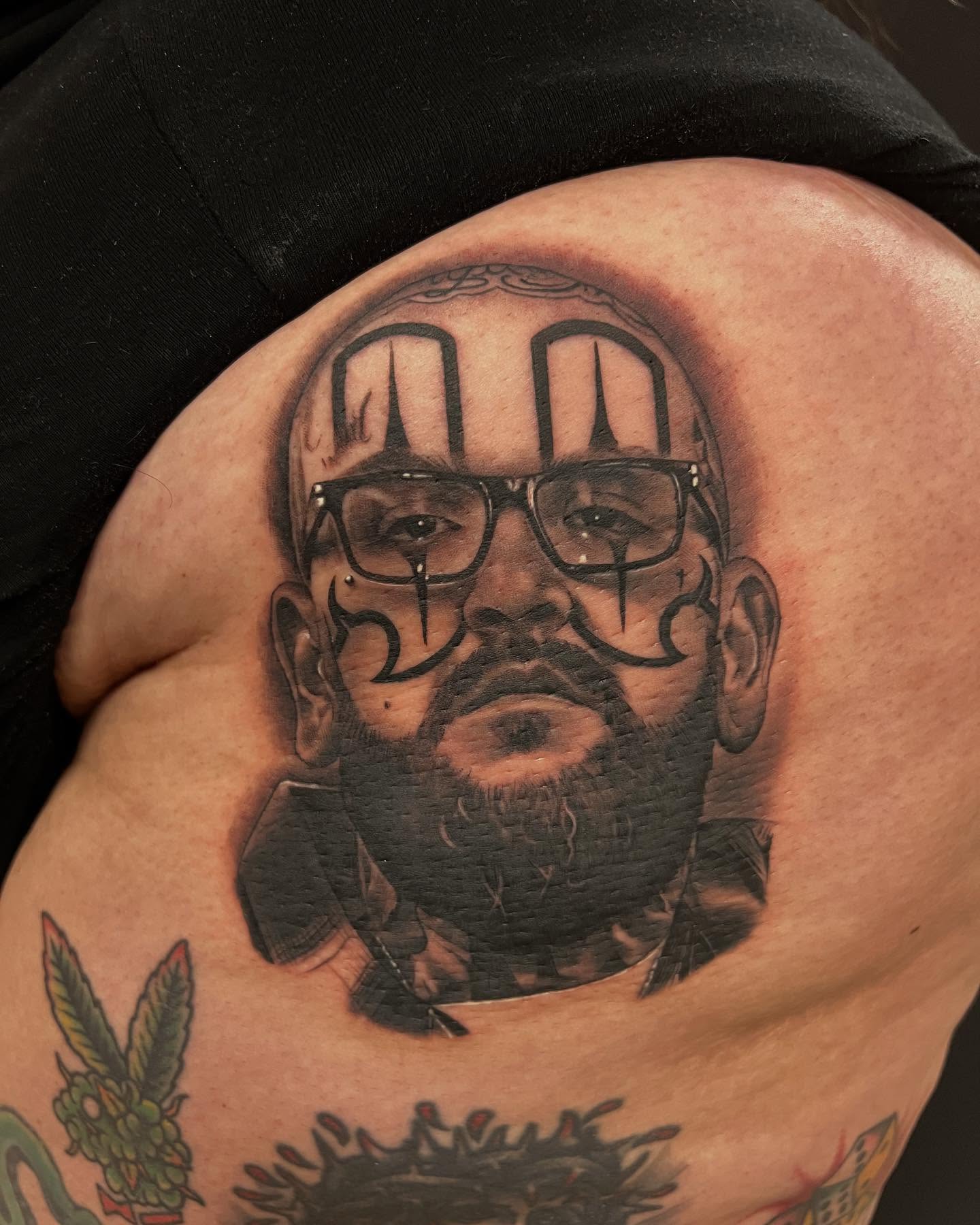 Portrait realism tattoo on the shoulder by Thomas Conard
