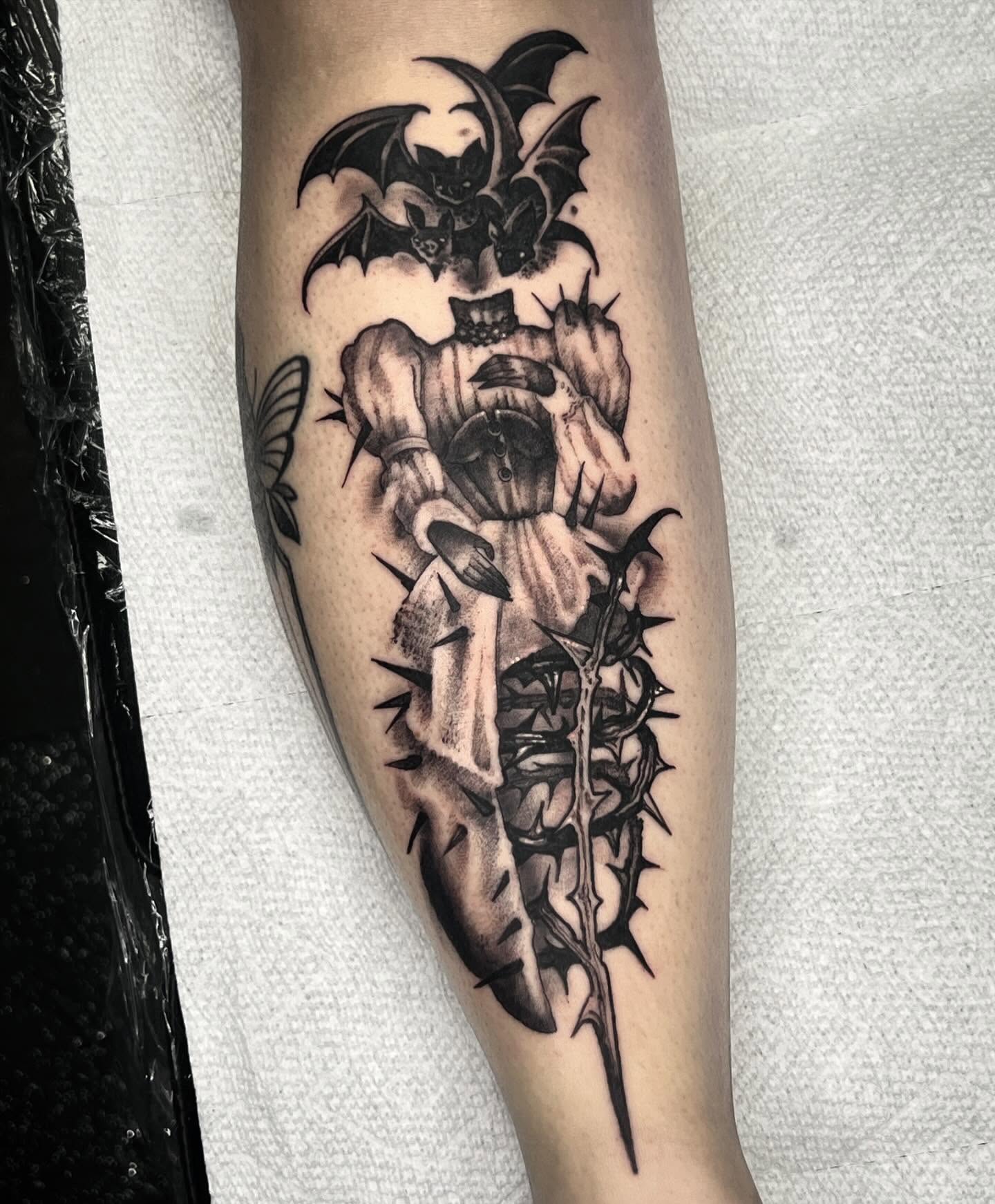 Bat and flower dark realism tattoo on the forearm by Briana Walker