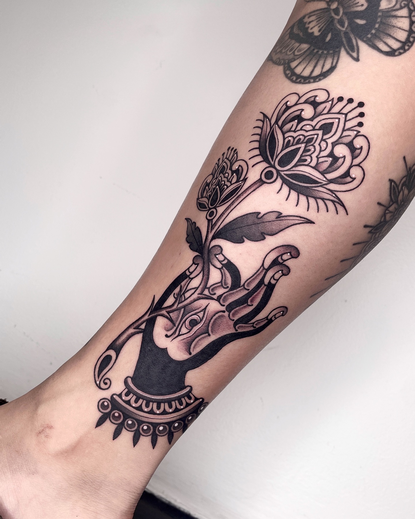 Lotus flower black and grey tattoo on the forearm by LA tattoo