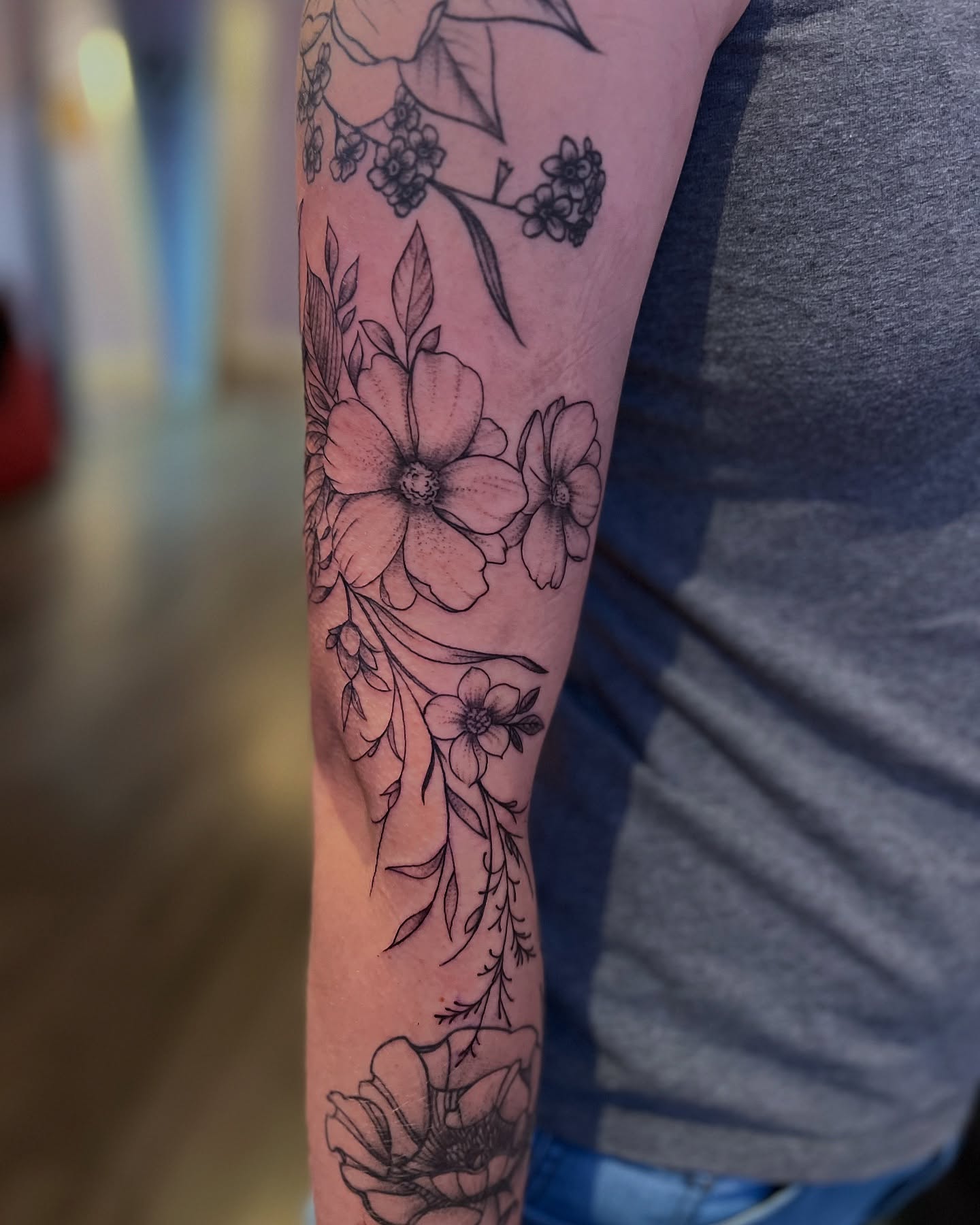 Floral arrangement black and grey tattoo on the forearm by Rose DeLisse