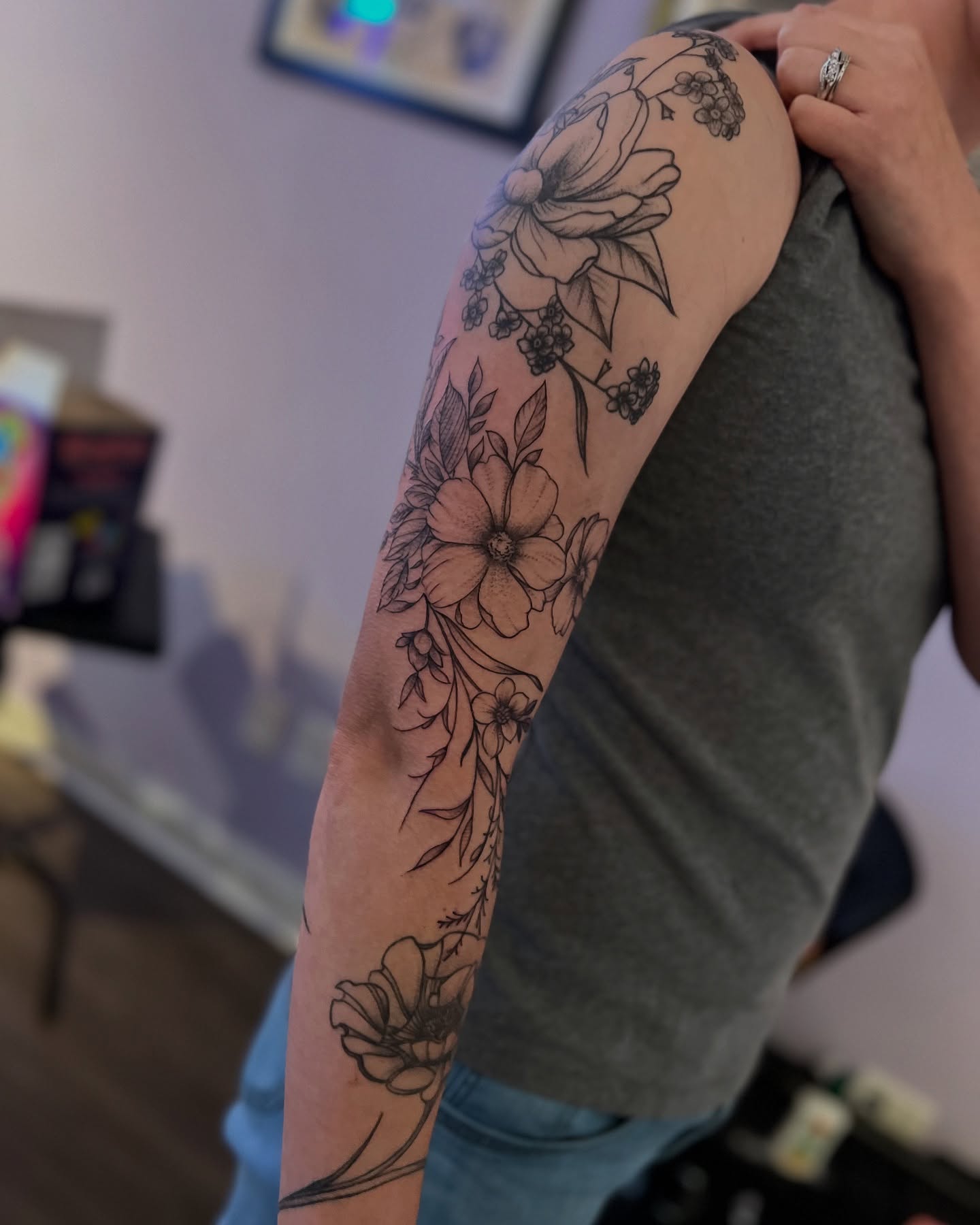 Floral bouquet black and grey tattoo on the forearm by Rose DeLisse