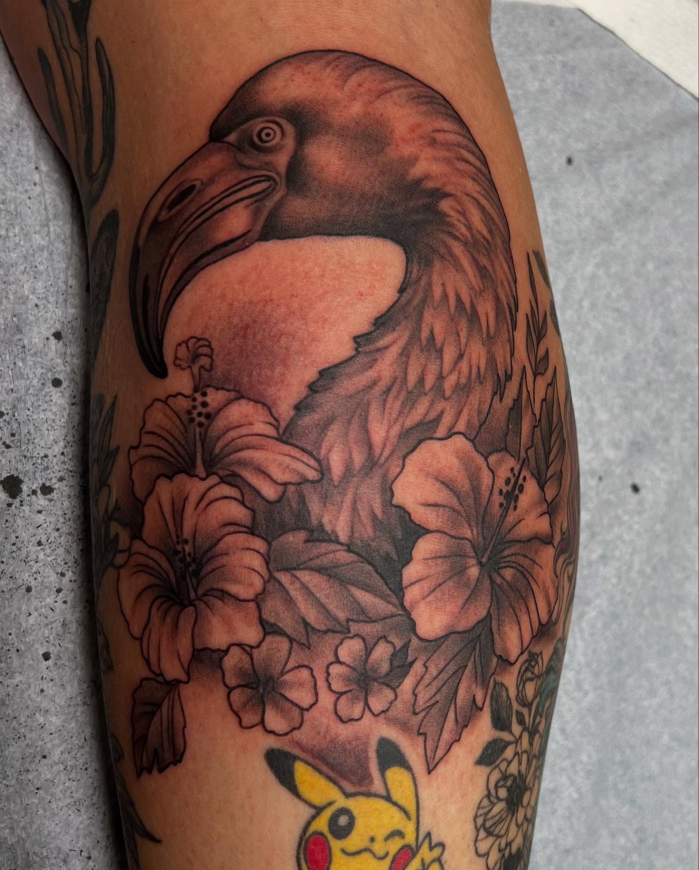 Eagle and hibiscus flowers realism tattoo on the forearm by Dustin Hysell