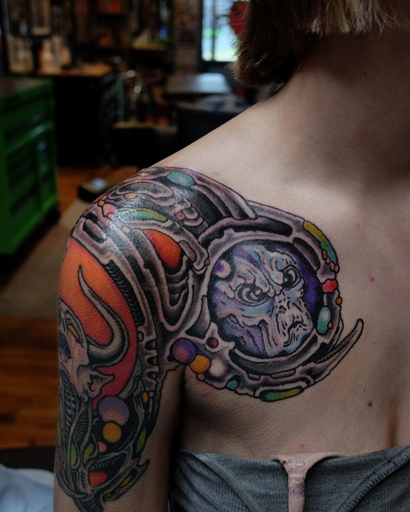 Astronaut helmet geometric tattoo on the shoulder by Zac Blevins