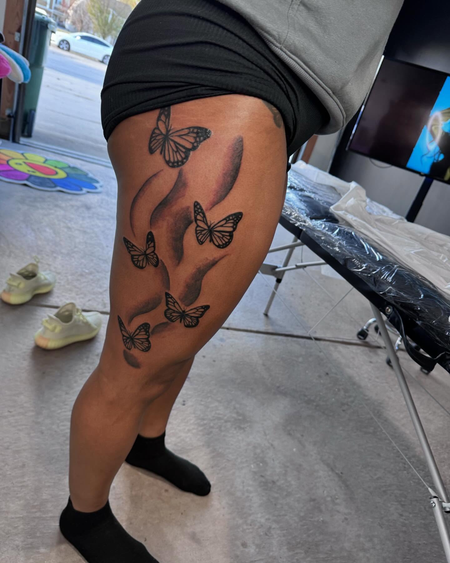 Butterflies black and grey tattoo on the thigh by Sierra 🩷