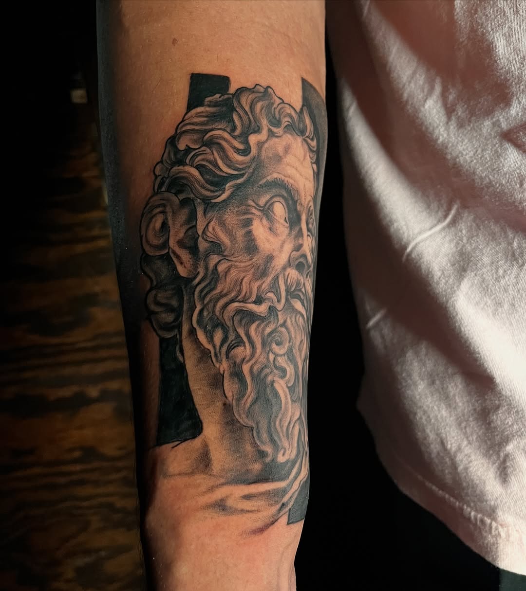 Bust of a classical figure surrealism tattoo on the forearm by "el asere, el zurdo"