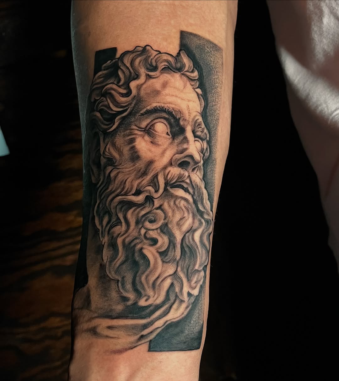 Bust of a man surrealism tattoo on the forearm by "el asere, el zurdo"