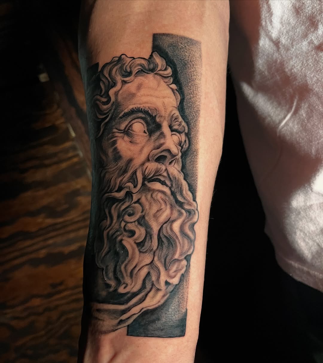 Bust of a man surrealism tattoo on the forearm by "el asere, el zurdo"