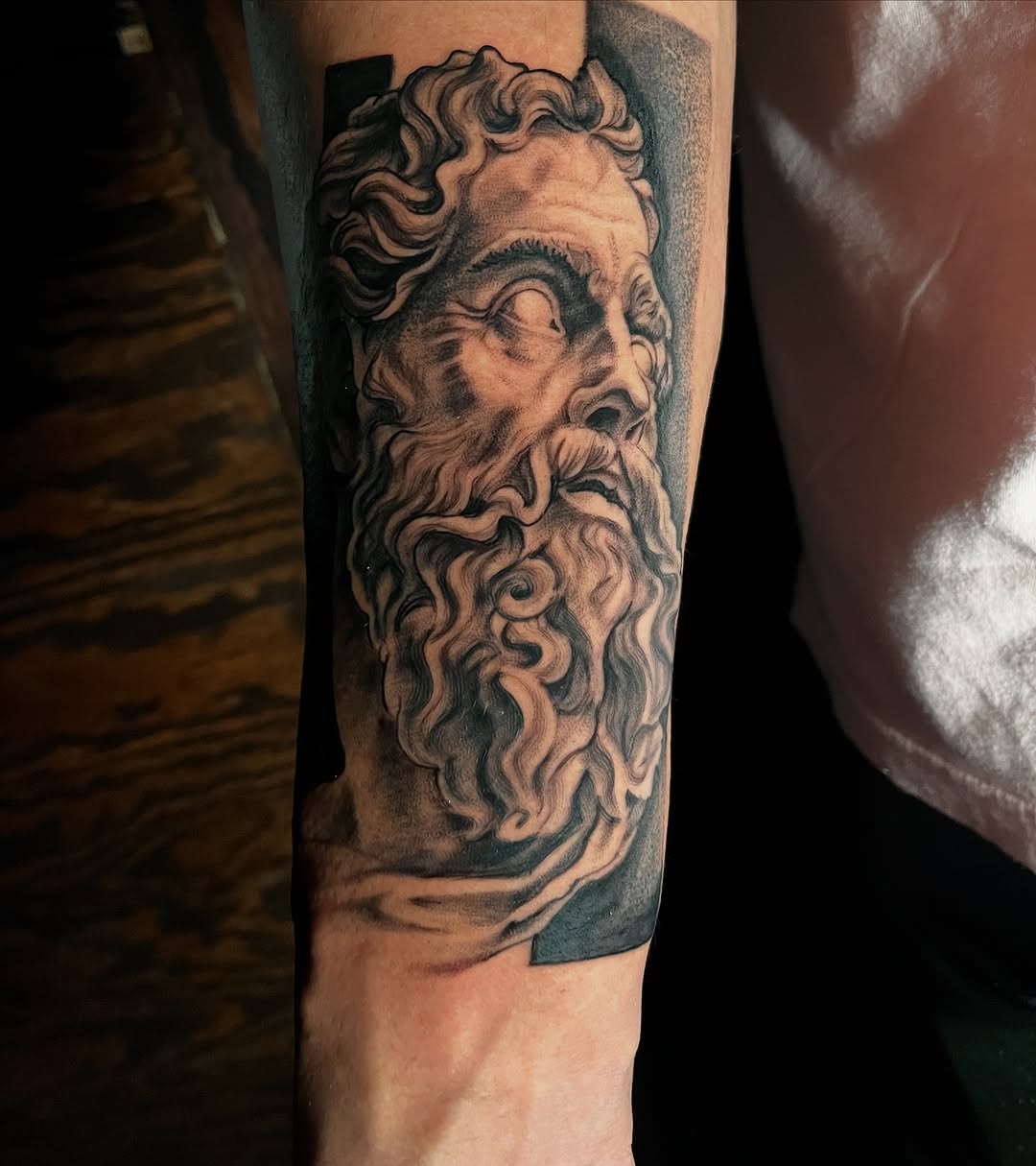 Bust of a man surrealism tattoo on the forearm by "el asere, el zurdo"