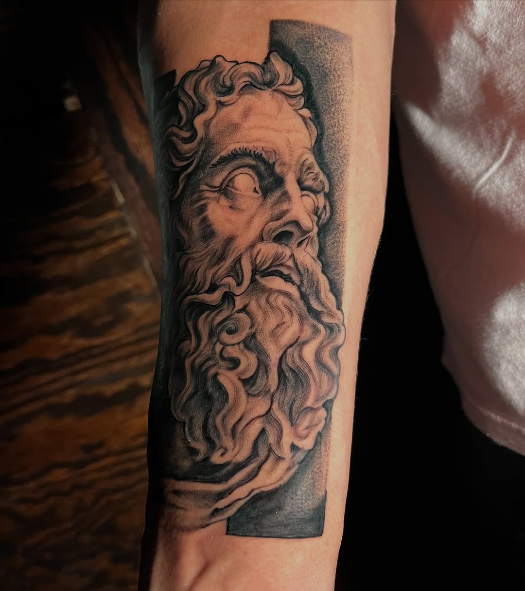 Sculpture bust of a man surrealism tattoo on the forearm by "el asere, el zurdo"