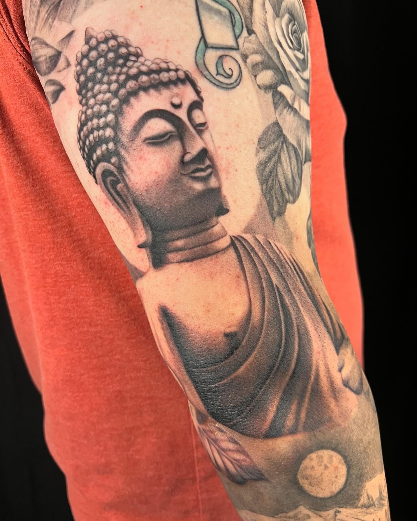 Buddha statue realism tattoo on the forearm by Sam Minter, Grafton, Massachusetts