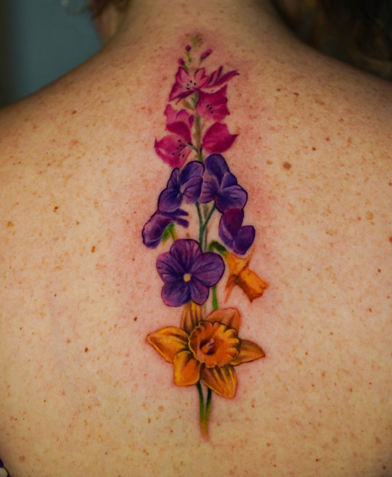 Flower bouquet realism tattoo on the back by David Gordon