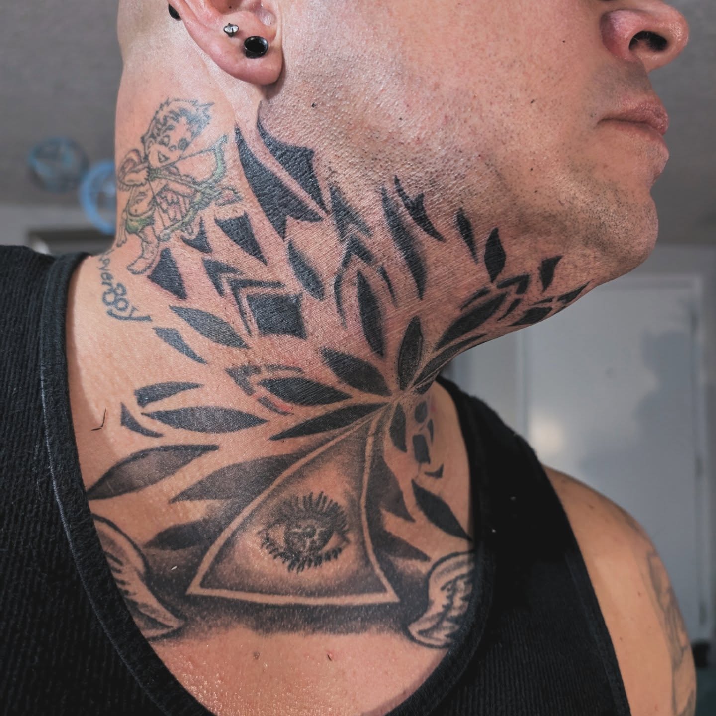 Eye and leaves geometric tattoo on the neck by Markus Hicks