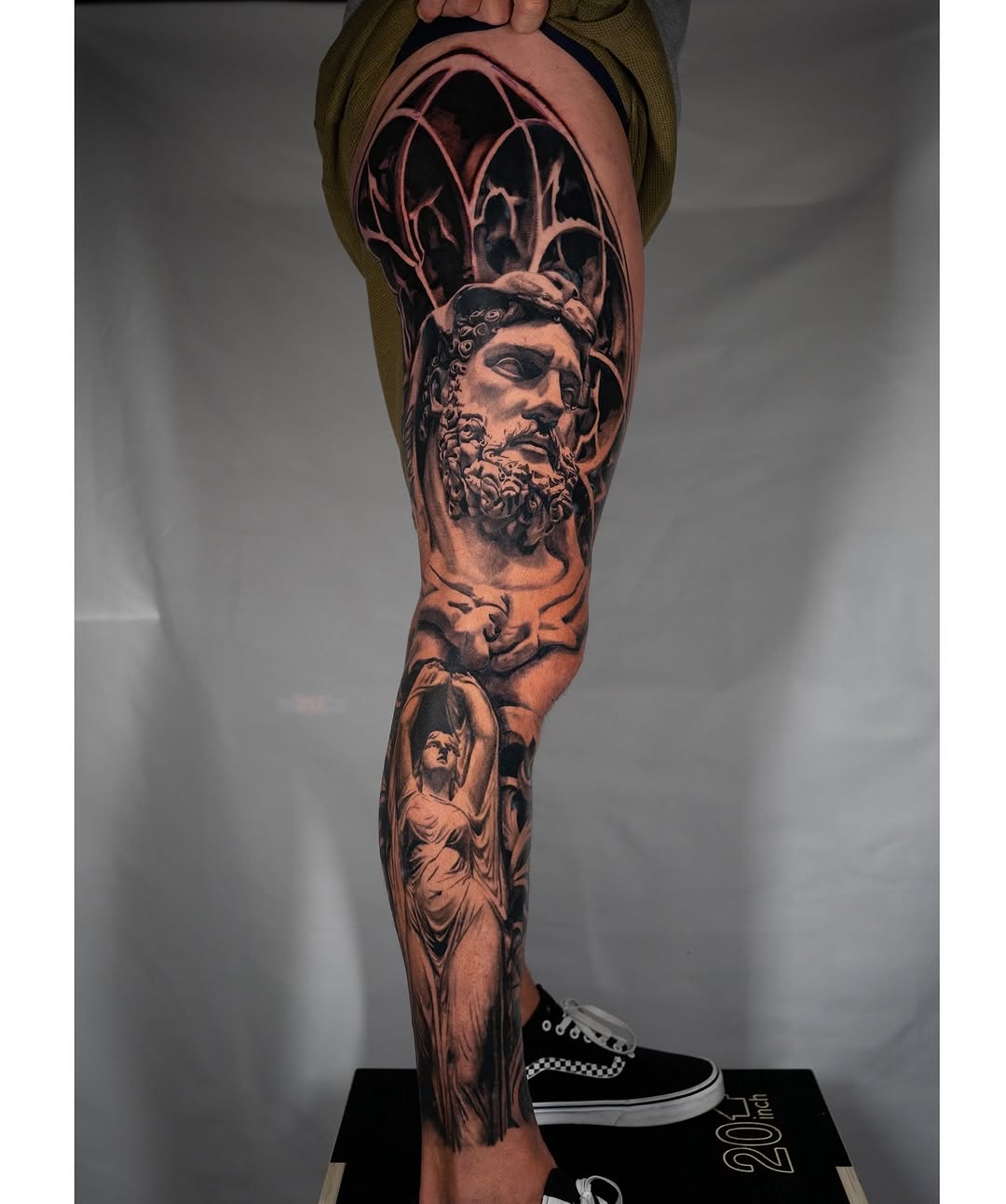 Classical statue and architectural elements surrealism tattoo on the leg by Nate