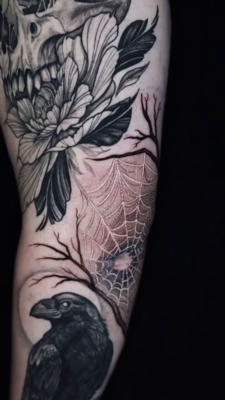 Skull and raven with flowers dark realism tattoo by Jules, Arlington, Texas