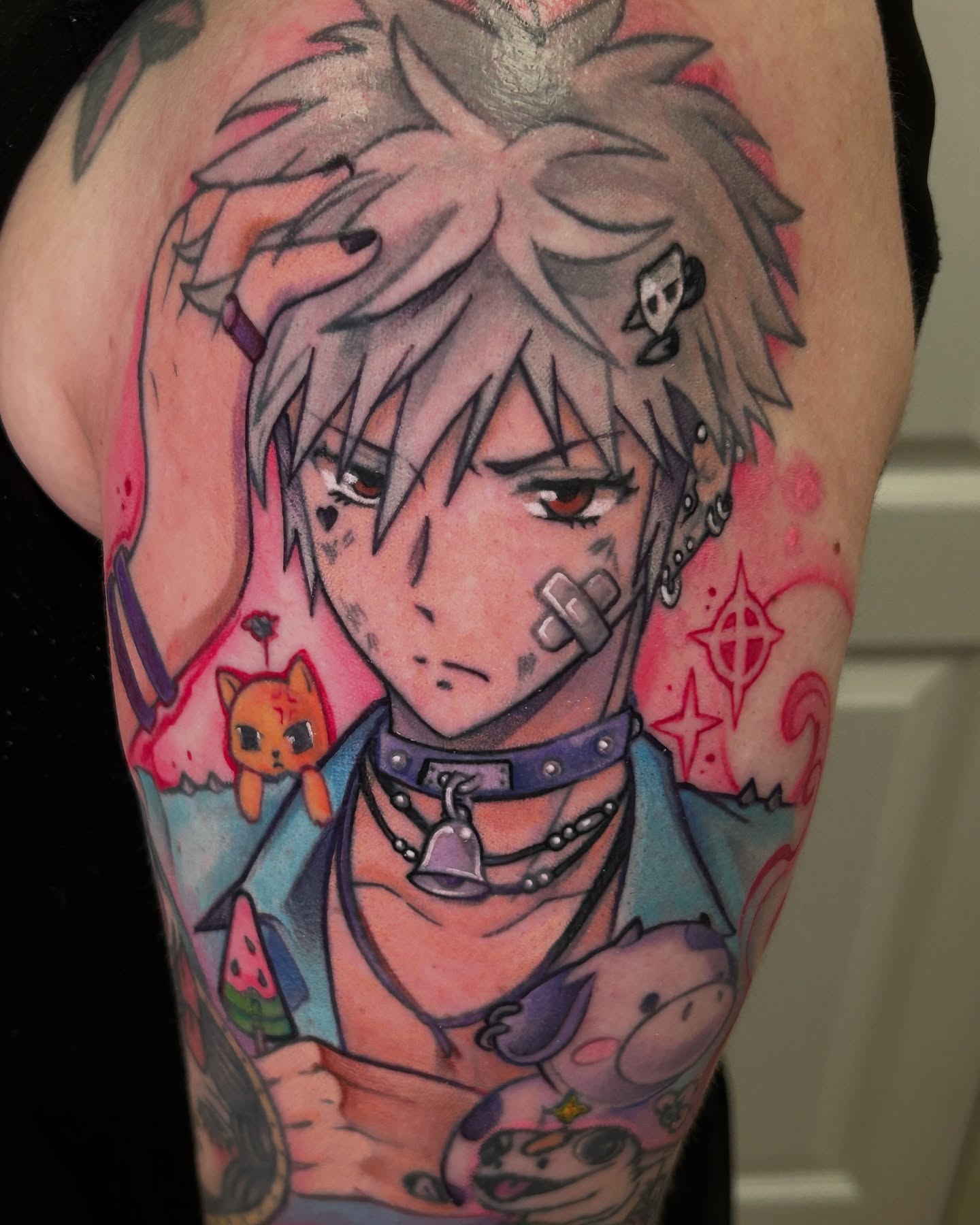 Anime character anime tattoo on the upper arm by Mando Castro