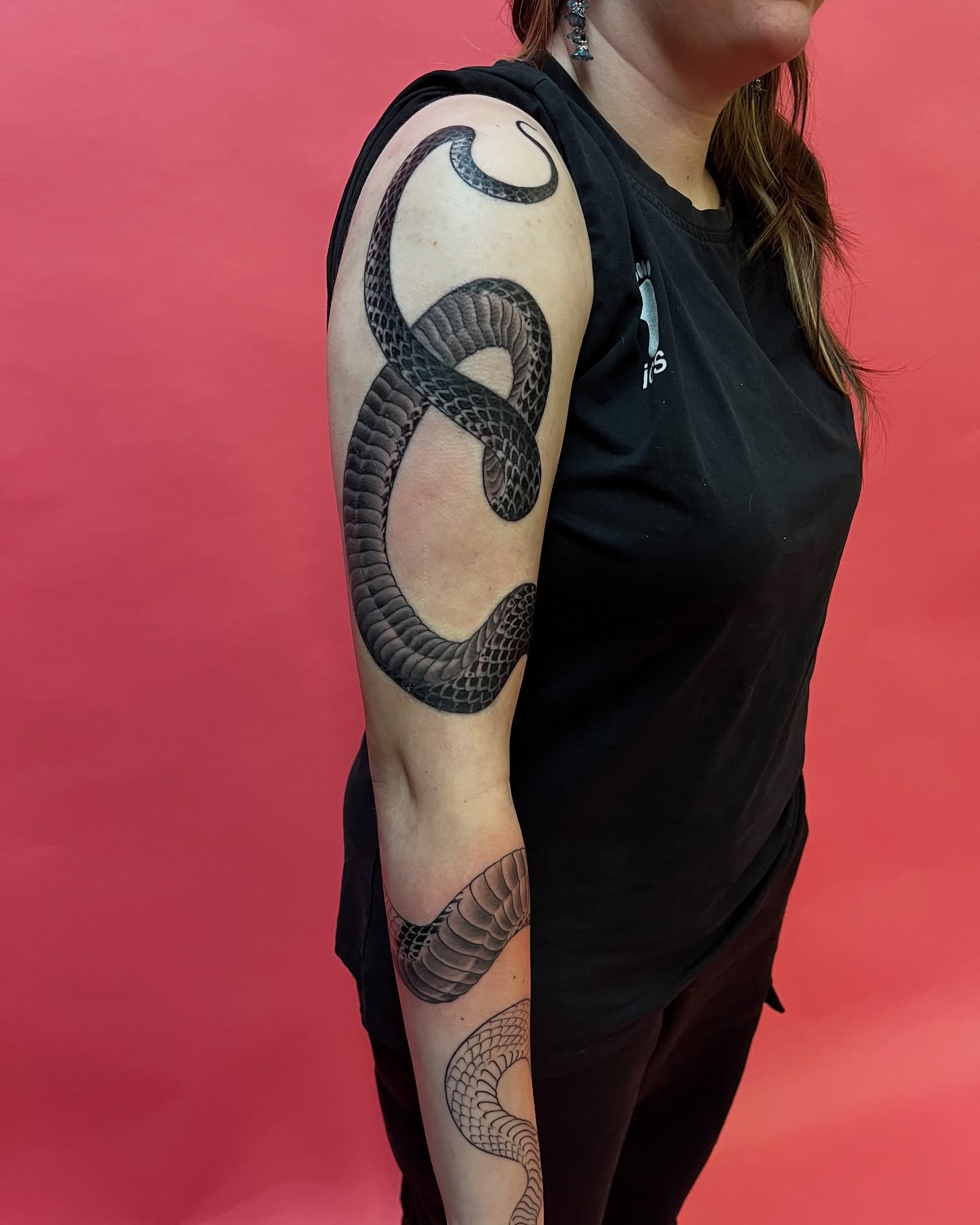 Snake black and grey tattoo on the upper arm by Angelique Sanders, Tellico Plains, Tennessee
