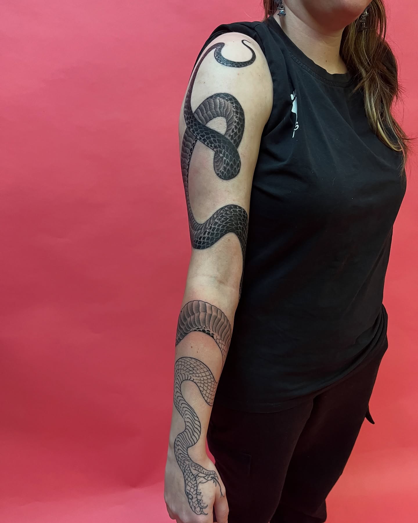 Snake black and grey tattoo on the upper arm by Angelique Sanders, Tellico Plains, Tennessee