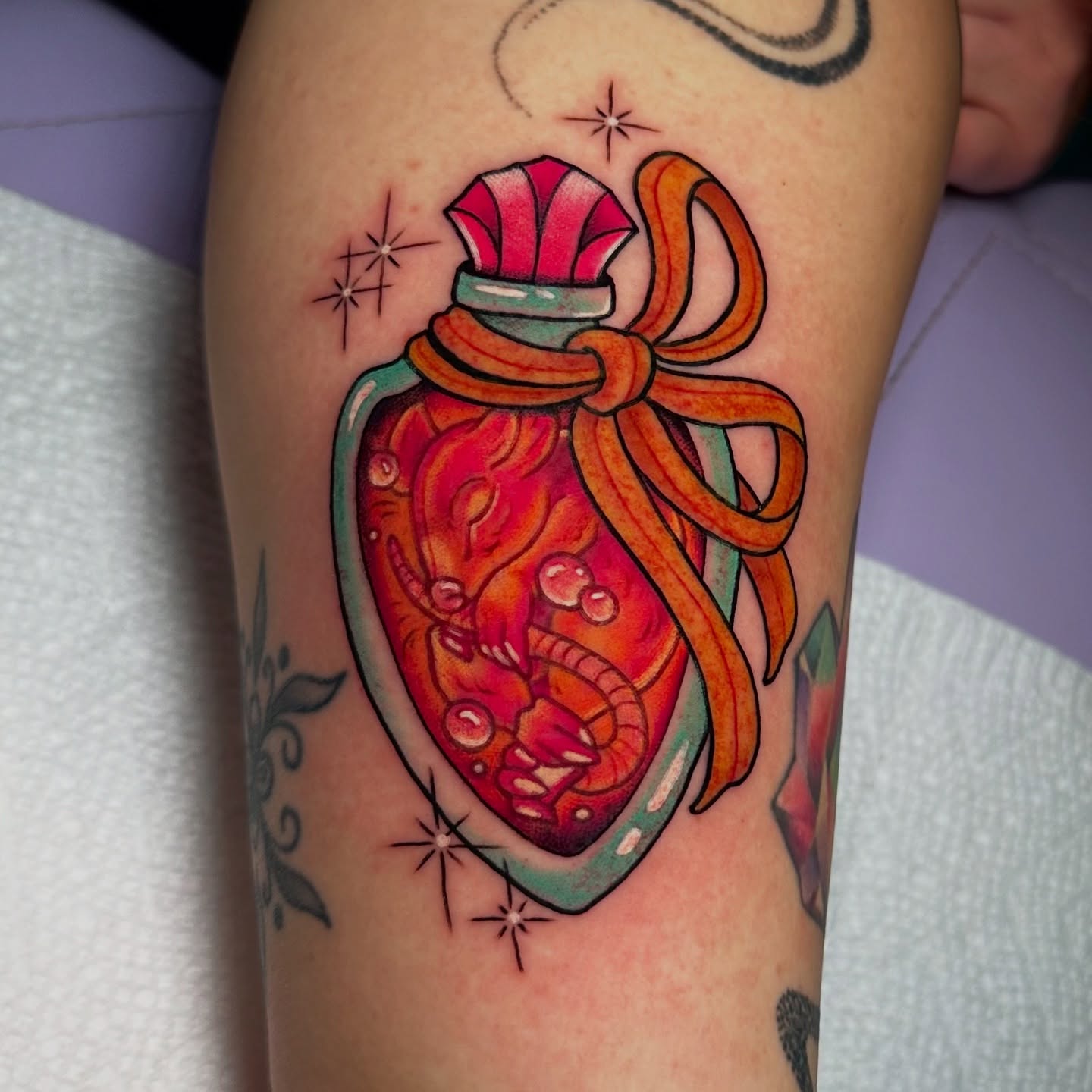 Heart in bottle new school tattoo on the forearm by Tayler Pearson, Fort Collins, Colorado