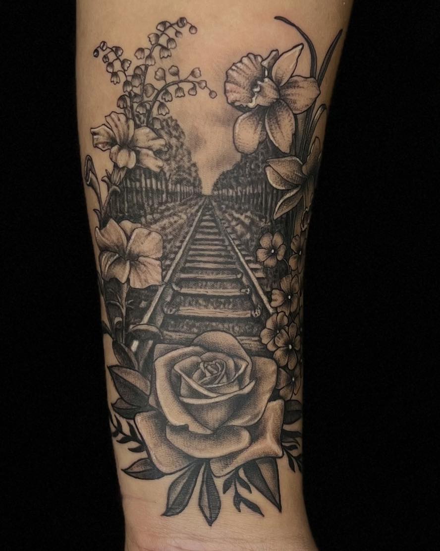 Railroad and flowers realism tattoo on the forearm by James Reed Tattoo artist