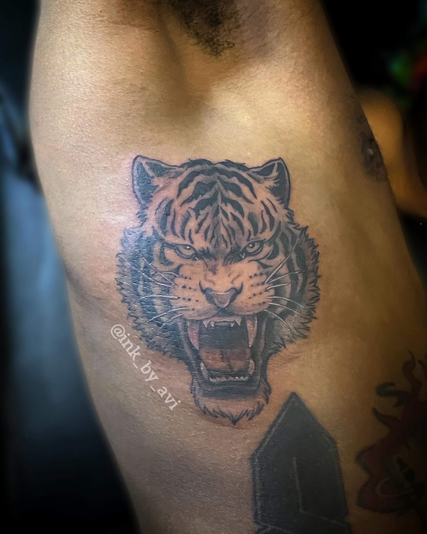 Tiger head realism tattoo on the thigh by Avi, Cleveland, Ohio