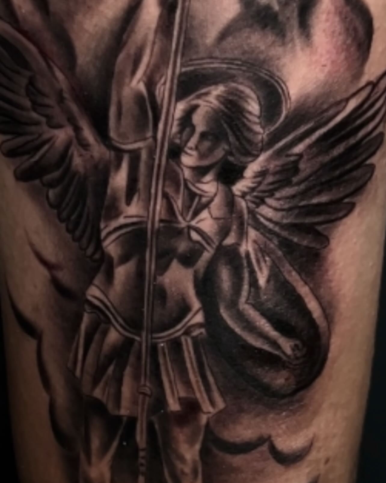 Angel with bow realism tattoo on the forearm by Kevyn Vidal