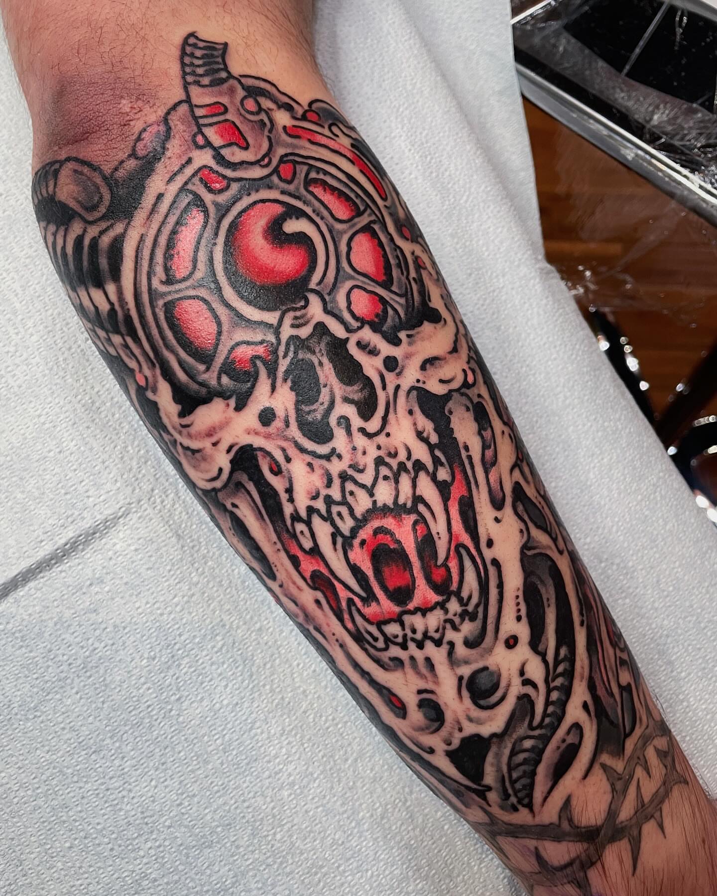 Cyborg skull dark realism tattoo on the forearm by Zac Blevins