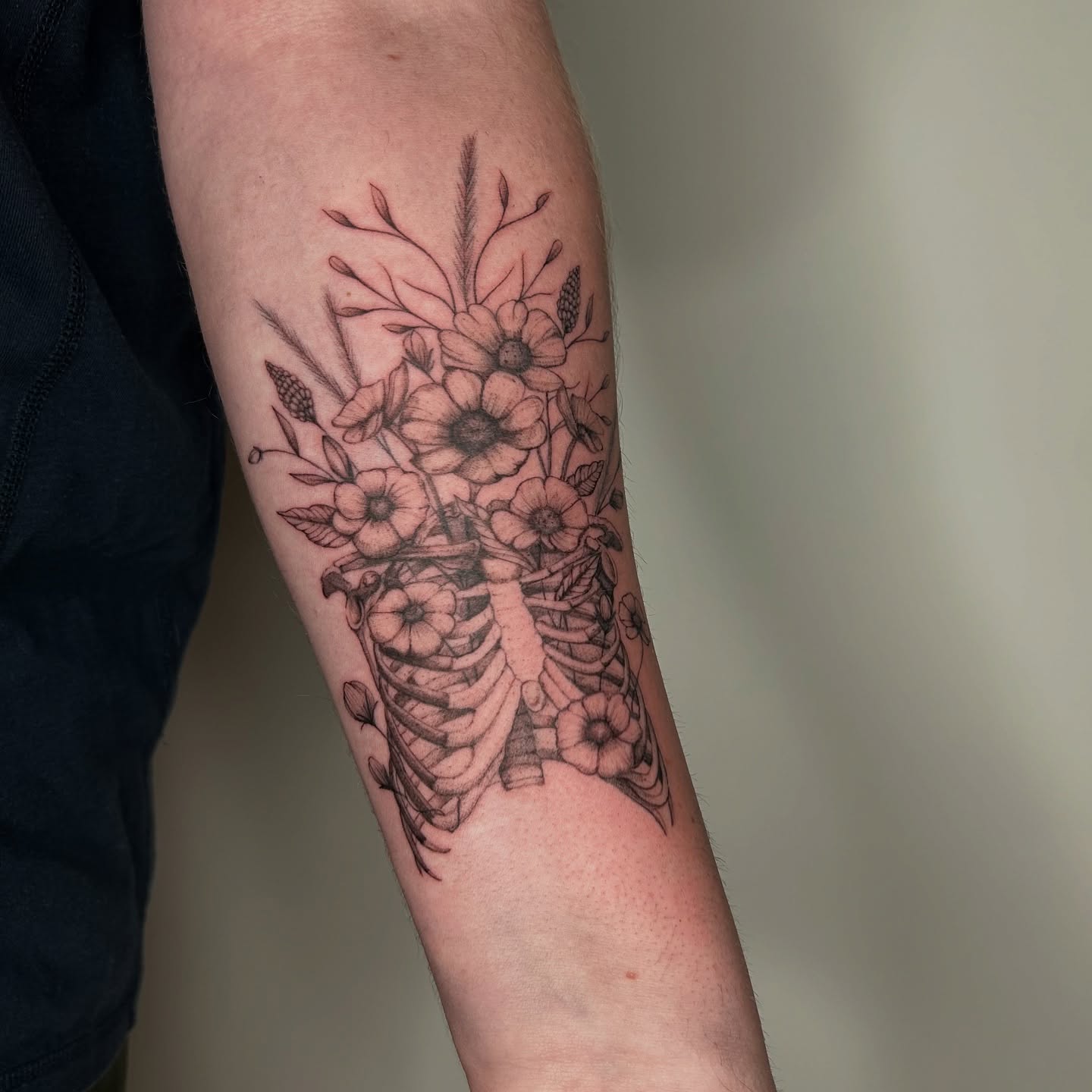 Flower bouquet with skeleton black and grey tattoo on the forearm by bre