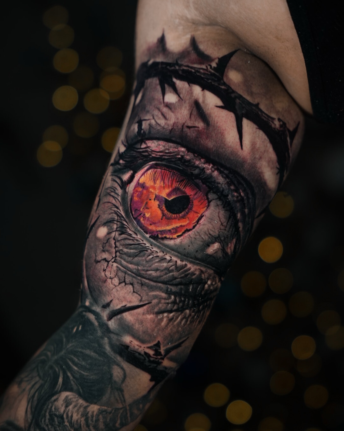 Eye with crown of thorns dark realism tattoo on the forearm by Bailey Lemus