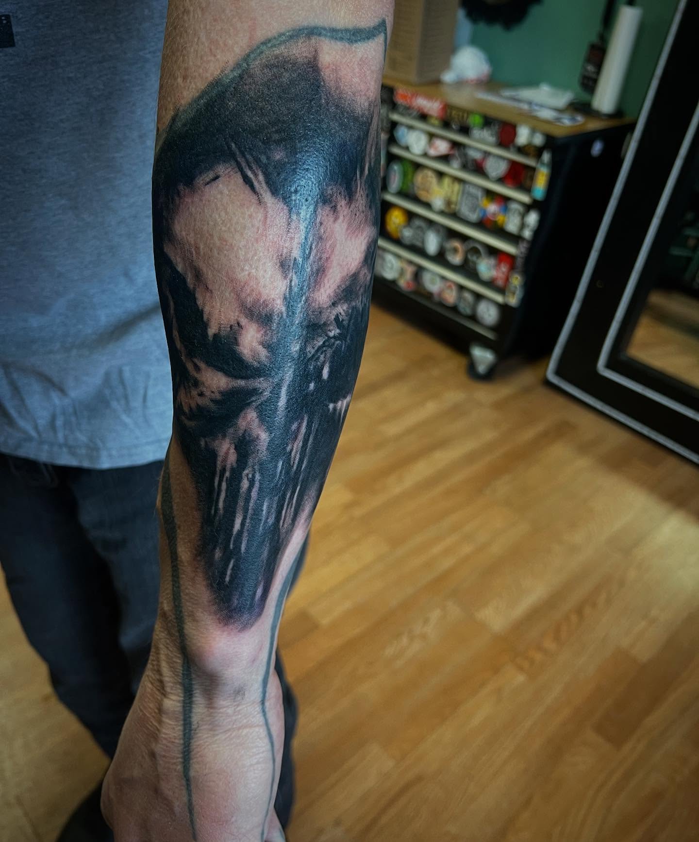 Mask realism tattoo on the forearm by Katie Sayre