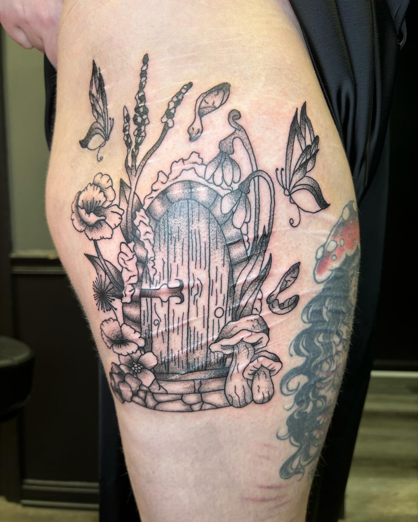 Door with fantasy elements realism tattoo on the thigh by kylie