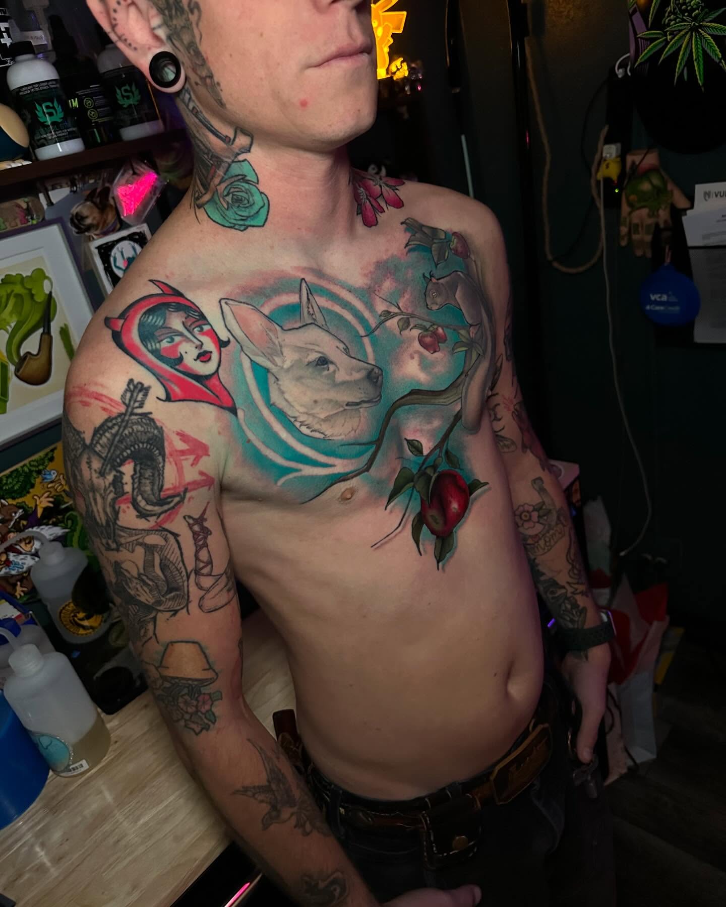 Dog and apple realism tattoo on the chest by Noel Martinez, Golden, Colorado