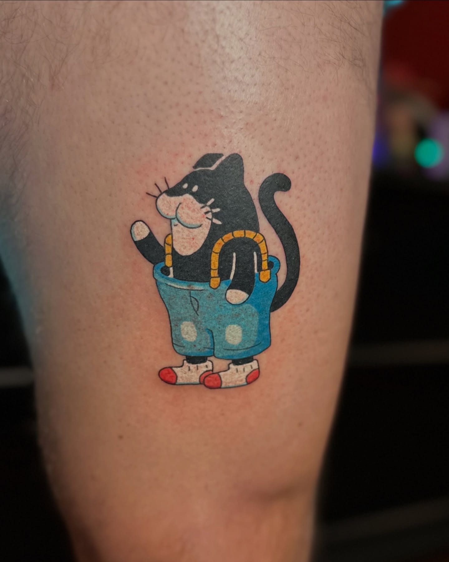 Cat illustrative tattoo on the thigh by Kellie Burch
