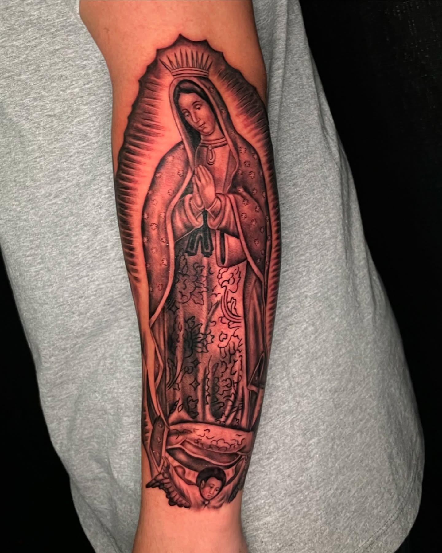 Our Lady of Guadalupe black and grey tattoo on the forearm by Luis Peña