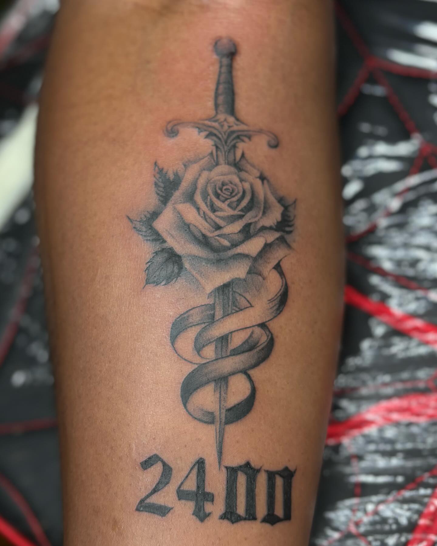 Sword and rose realism tattoo on the forearm by orlando